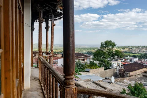 A wooden balcony looking out over the rooftops of Harar
